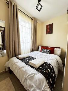 a bed in a room with a window at My Humble Abode - Machakos in Machakos