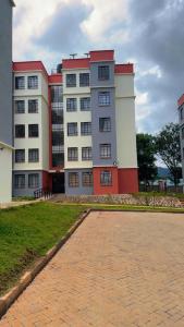 a large white and red building with a brick driveway at My Humble Abode - Machakos in Machakos