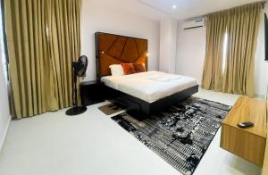 a hotel room with a bed and a rug at LetMax Homes in Ikeja