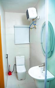 a bathroom with a toilet and a sink and a mirror at LetMax Homes in Ikeja +11 photos