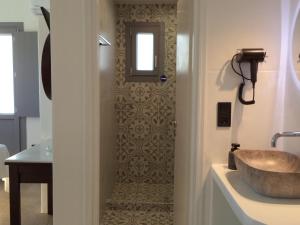 a bathroom with a sink and a mirror at Sea Melody Studios in Plaka +46 photos