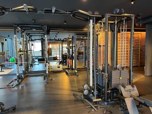 a gym with a lot of equipment in a room at Haus Wildschütz by Hotel Tirolerhof in Tux