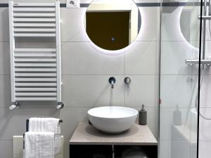 a bathroom with a bowl sink and a mirror at Casa Obìa in Cagliari +12 photos
