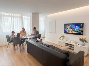 a group of people sitting at a table in a living room at Oeiras living and work in Oeiras