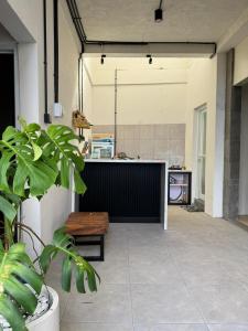 a room with a counter and a bench in a kitchen at Adi Bali Homestay in Uluwatu +34 photos
