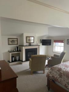 a living room with a bed and a fireplace at The Old Lyme Inn in Old Lyme