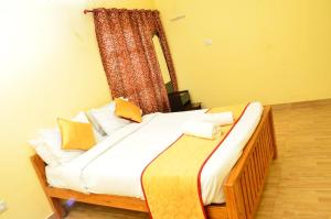 a bedroom with a large bed with a window at Redfox Villa - Kodaikanal in Kodaikānāl +19 photos