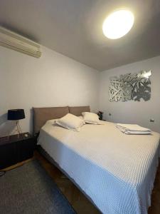 a bedroom with a bed with a white bedspread at Катедрала Варна in Varna City