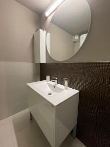 a bathroom with a white sink and a mirror at Катедрала Варна in Varna City