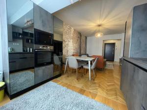 a kitchen and dining room with a table and chairs at Катедрала Варна in Varna City +4 photos