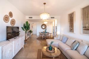 a living room with a couch and a tv at Seaview Apartment - COTO REAL Duquesa in Manilva