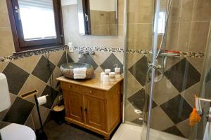 a bathroom with a sink and a shower at Räuberlager 15 in Dammbach