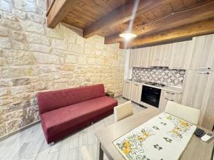 a living room with a red couch and a table at B&B Mairè in Scicli