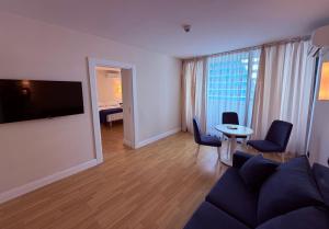 a living room with a couch and a table at Sun Set Apartments in Batumi