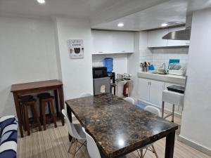 a kitchen and dining room with a table and chairs at Door207 Homestay in Baguio