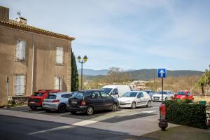 a bunch of cars parked in a parking lot at Maison de l'Orb in Cessenon