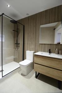 a bathroom with a toilet and a sink and a shower at Niu Hostal in Casinos +33 photos