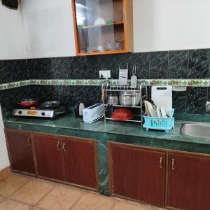 a kitchen with a counter with a sink and a counter top at North face Studio in Pokhara