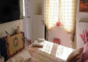 a bedroom with a bed with a towel on it at Elias Home in Volos