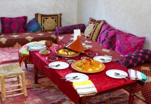 a living room with a table with food on it at Adrar view lodge in Imlil