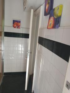 a bathroom with paintings on the wall and a door at Pacor in Mar del Plata