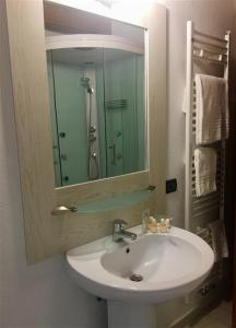 a bathroom with a sink and a mirror at La Casa Di Martino in Cesana Torinese +20 photos