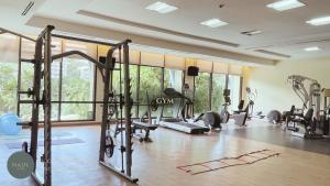 a gym with several treadmills and machines in a room at Nade Suites - Pico De Loro MIB 601 in Nasugbu +13 photos