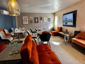 a waiting room with orange couches and tables at Drive Point (Adventure Lake Resort) in Asparukhovo