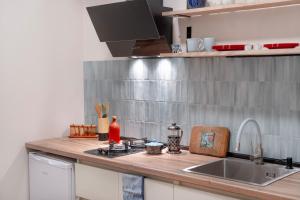a kitchen counter with a sink and a stove at Avgarose in Itʼkhvisi +14 photos