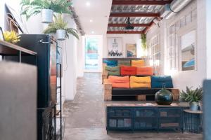 a living room with a couch with colorful pillows at Koba Hostel in San Sebastián