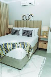 a bedroom with a large bed with two rings on it at Tlou Luxe stay in Gaborone +56 photos