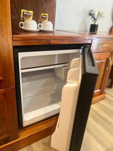 a microwave oven with its door open in a kitchen at Ruby Hotel in Nhơn Trạch