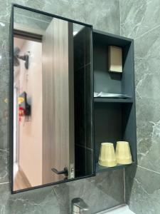 a mirror above a sink in a bathroom at Ruby Hotel in Nhơn Trạch +34 photos