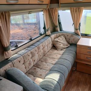 a couch in the back of a camper van at CaraCaux in Le Torp-Mesnil +1 photo
