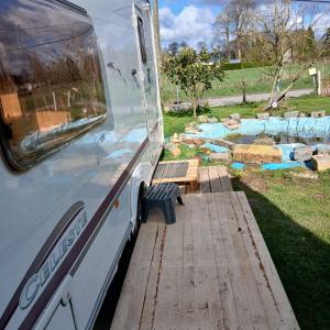 a bus parked with a bench in a park at CaraCaux in Le Torp-Mesnil