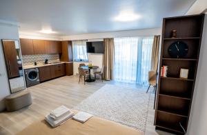 a large room with a kitchen and a living room at Piatra Studio in Piatra Neamţ +8 photos