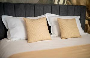 a white bed with four pillows on it at Piatra Studio in Piatra Neamţ