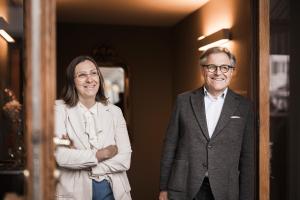 a man and a woman standing in front of a mirror at Boutique & Gourmet Hotel Orso Grigio - Grauer Bär in San Candido