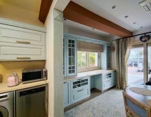 a kitchen with white cabinets and a counter top at 7 Bdr Villa with Heated Pool & Spa in Mazotos