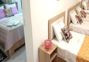 a small room with two beds and a table at Elias Home in Volos
