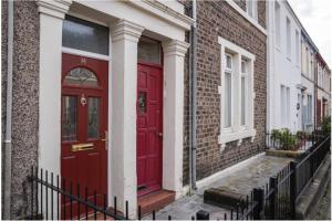 a red door on the side of a building at Affleck Street in Gateshead