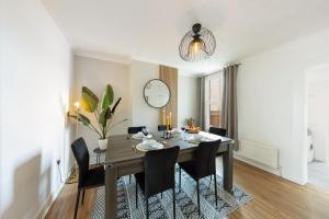 a dining room with a wooden table and chairs at 3Bd Cosy Home-Wifi-Pool Table- Gilly Hideaway in Gillingham