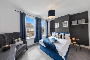 a bedroom with a bed and a couch and window at 3Bd Cosy Home-Wifi-Pool Table- Gilly Hideaway in Gillingham