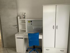 a white desk with a blue chair in a room at Bed and Breakfast da Giuseppe, Camere vicino stabilimento Ferrari in Fiorano Modenese