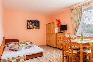 a bedroom with a bed and a dining table at Vila Horal in Liptovský Mikuláš