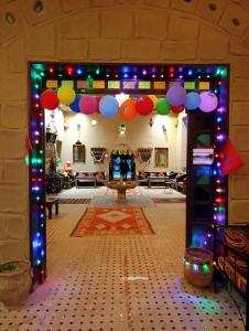 a large room with a colorful arch with lights at Kasbah Hotel Ziz Palace Rissani in Rissani +56 photos
