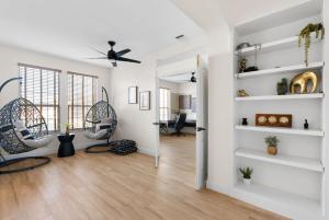 a living room with white walls and white shelves at Large Groups' Luxury House - Pool - Sleep 22 in Round Rock