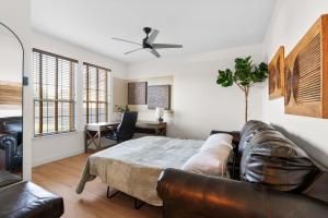 a living room with a leather couch and a table at Large Groups' Luxury House - Pool - Sleep 22 in Round Rock
