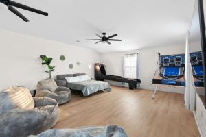 a living room with a couch and a bed and a piano at Large Groups' Luxury House - Pool - Sleep 22 in Round Rock