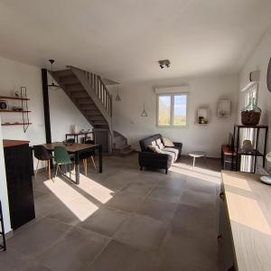 a living room with a couch and a table at Logement 2 - proche Le Mans in Aigné